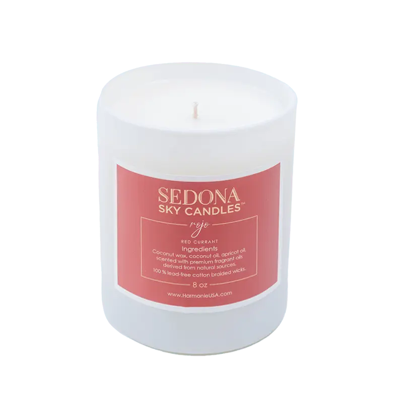 a white candle glass from Sedona Sky Candles with a Rojo label.