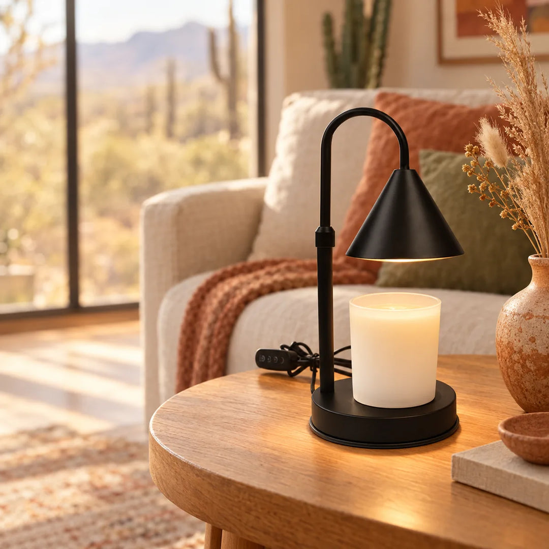 Harmonie matte black candle warmer lamp melting a coconut wax candle on a side table, no flame