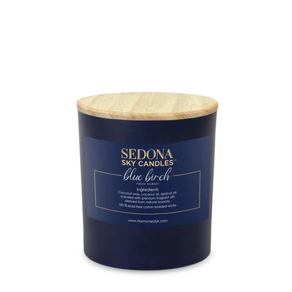 A blue scented candle with a wooden lid, labeled 'SEDONA SKY CANDLES blue birch'.