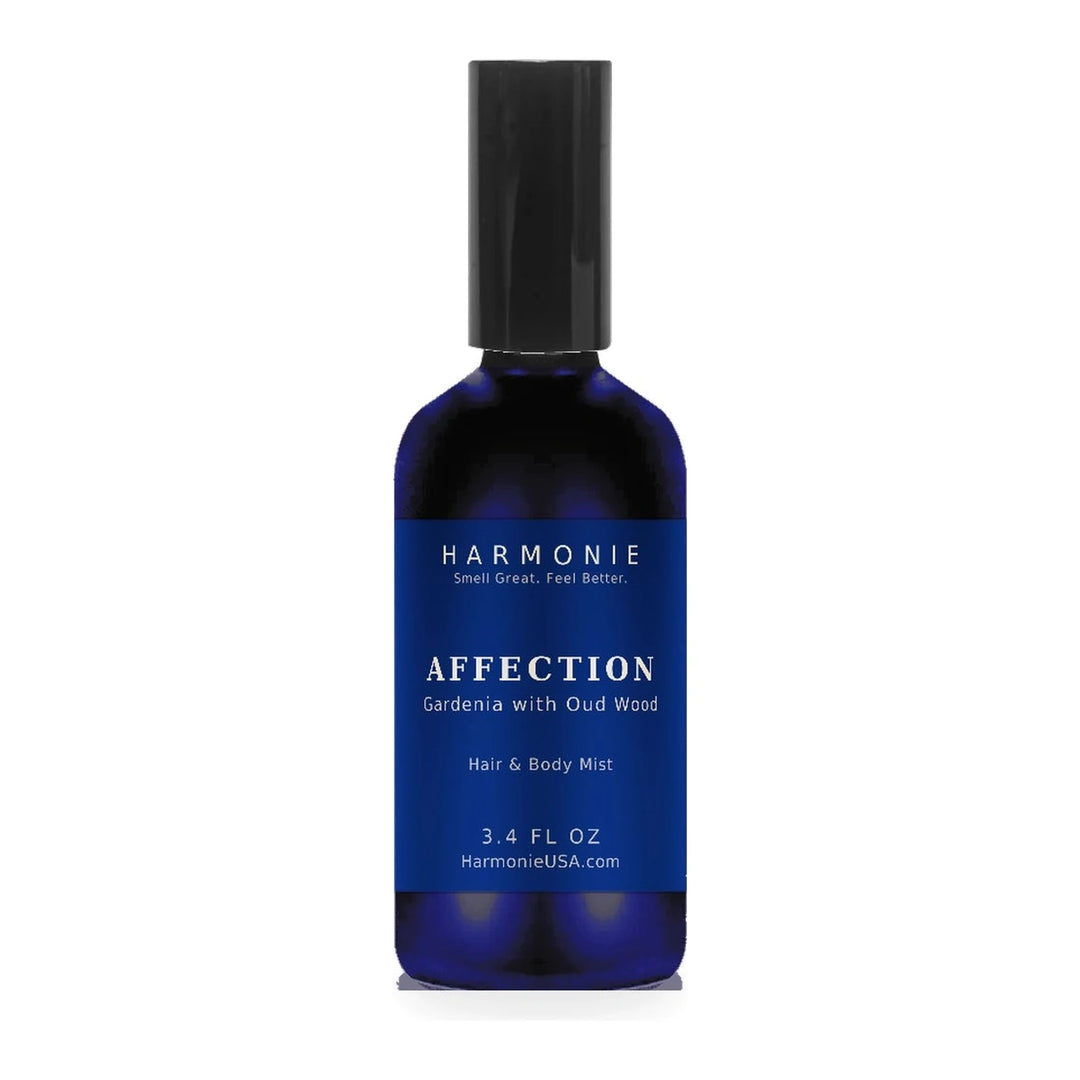 Harmonie Affection 3.4 oz hair and body mist, gardenia with oud wood, sapphire blue glass spray bottle on a white background