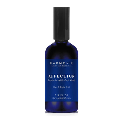 Harmonie Affection 3.4 oz hair and body mist, gardenia with oud wood, sapphire blue glass spray bottle on a white background
