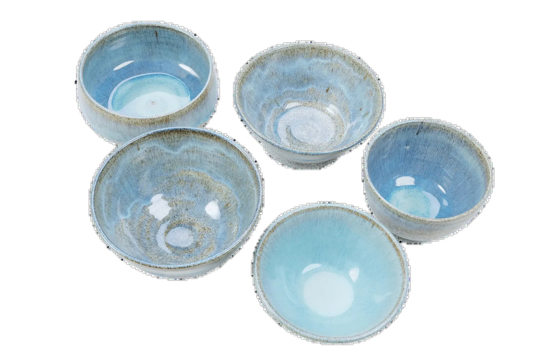 Blue-glazed dragonfruit clay bowls viewed from above showing glaze variation between pieces