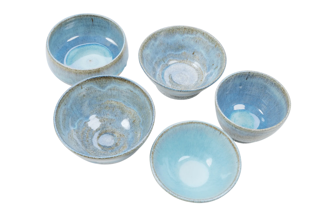 Blue-glazed dragonfruit clay bowls viewed from above showing glaze variation between pieces