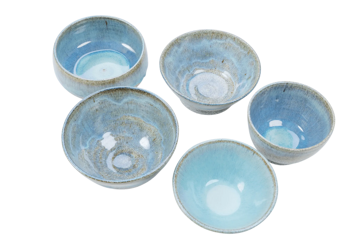Blue-glazed dragonfruit clay bowls viewed from above showing glaze variation between pieces