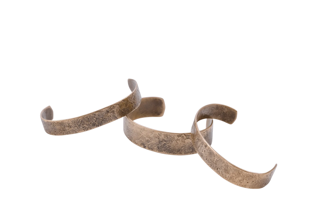 Dark Sky cuffs laid in a row showing the hammered surface texture
