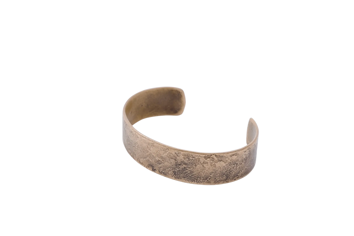 Large copper Dark Sky cuff photographed from the front against a light ground