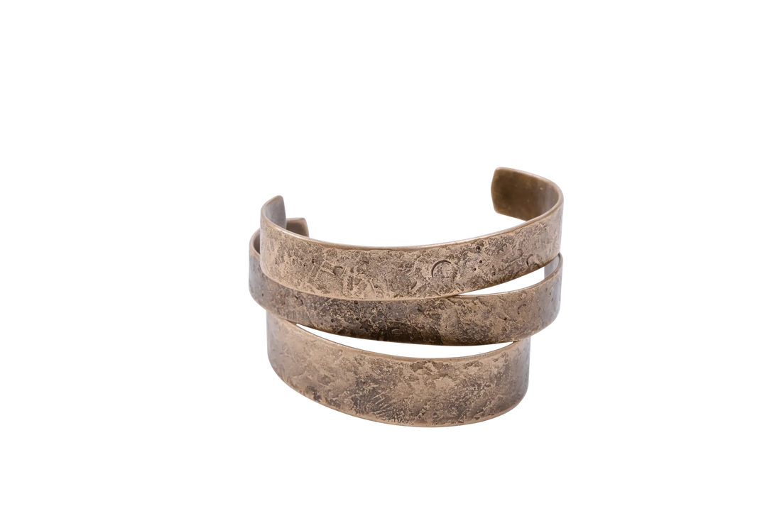 Copper and silver cuffs nested together showing the hammered face