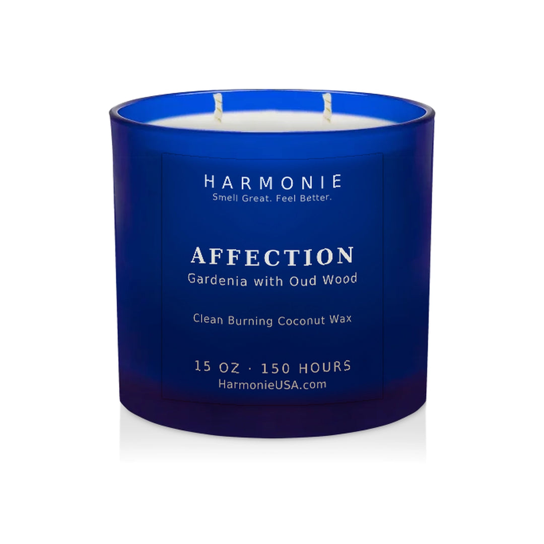 Harmonie Affection coconut wax candle, 15 oz, 150 hour burn time, frosted sapphire blue glass vessel with two wicks, unlit, on a white background