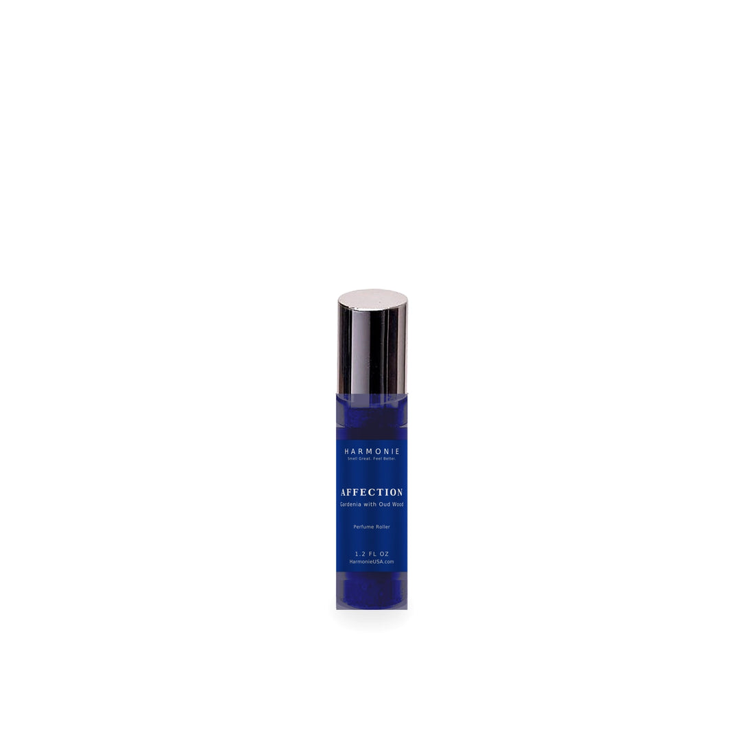 Harmonie Affection 1.2 oz perfume roller, Gardenia with Oud Wood, sapphire blue glass roller bottle on a white background