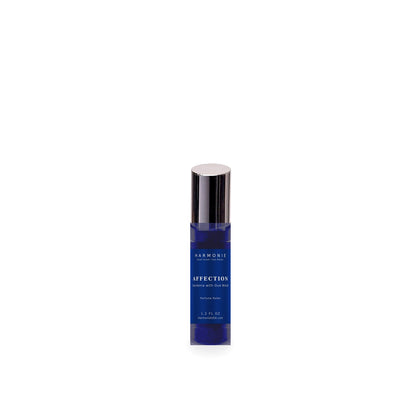 Harmonie Affection 1.2 oz perfume roller, Gardenia with Oud Wood, sapphire blue glass roller bottle on a white background