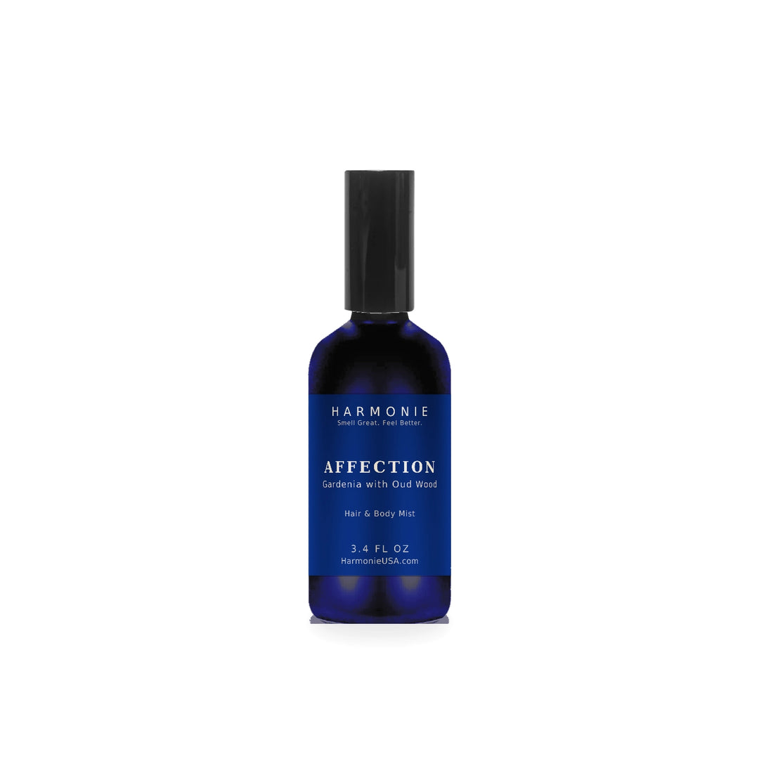 Harmonie Affection 3.4 oz hair and body mist, gardenia with oud wood, sapphire blue glass spray bottle on a white background