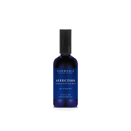 Harmonie Affection 3.4 oz hair and body mist, gardenia with oud wood, sapphire blue glass spray bottle on a white background