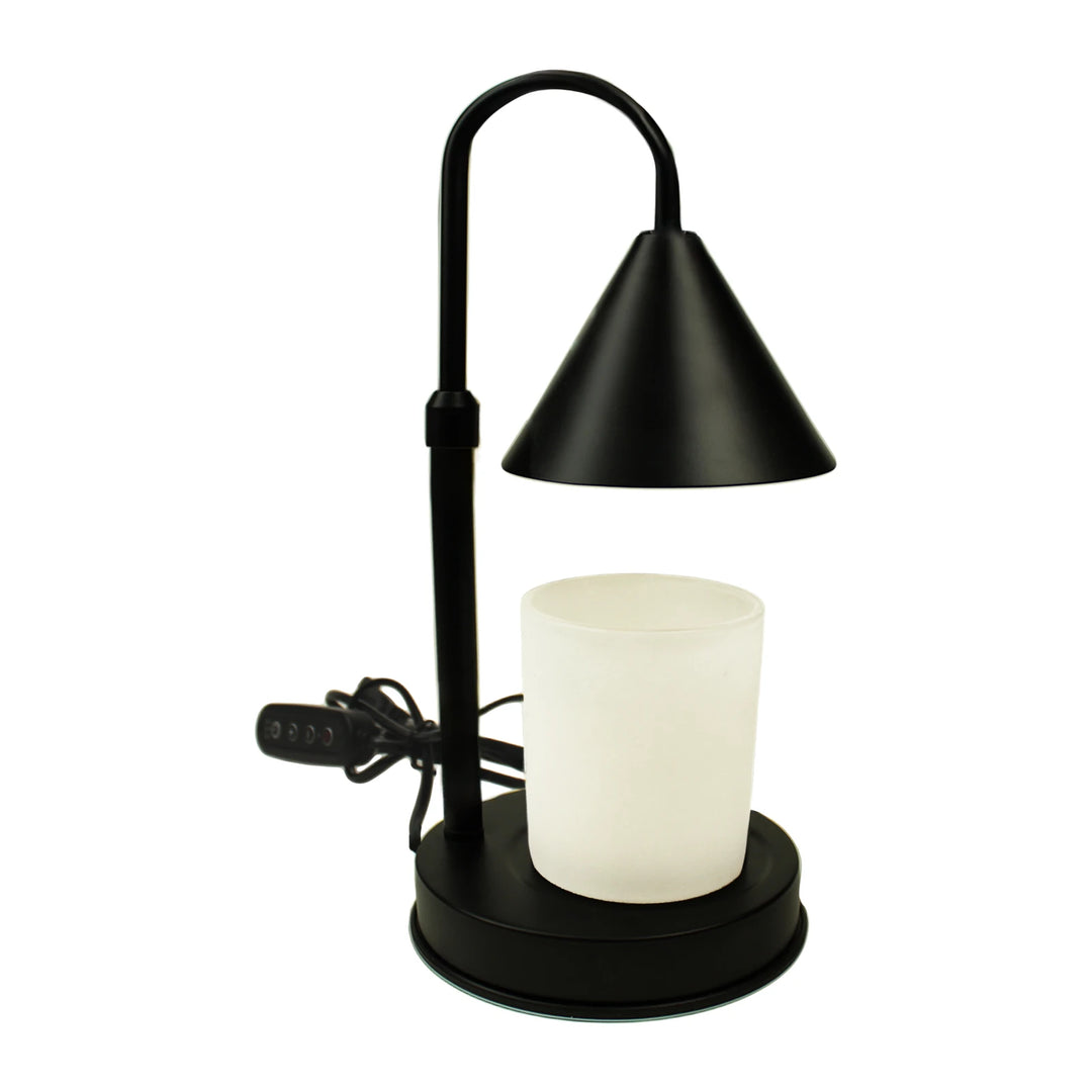 Harmonie matte black candle warmer lamp, flameless, with a white coconut wax candle on the base and a coiled black power cord, on a pure white background