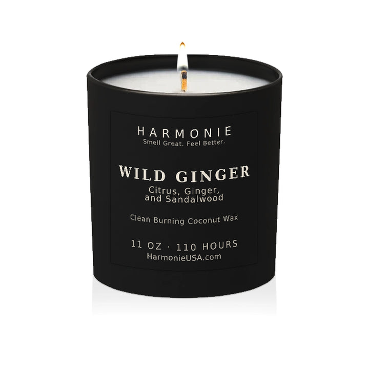 Harmonie Wild Ginger coconut wax candle, 11 oz, 125 hour burn time, matte black glass vessel with a single lit wick, on a white background