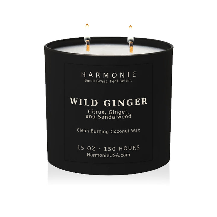 Harmonie Wild Ginger coconut wax candle, 15 oz, 150 hour burn time, matte black glass vessel with two lit wicks, on a white background