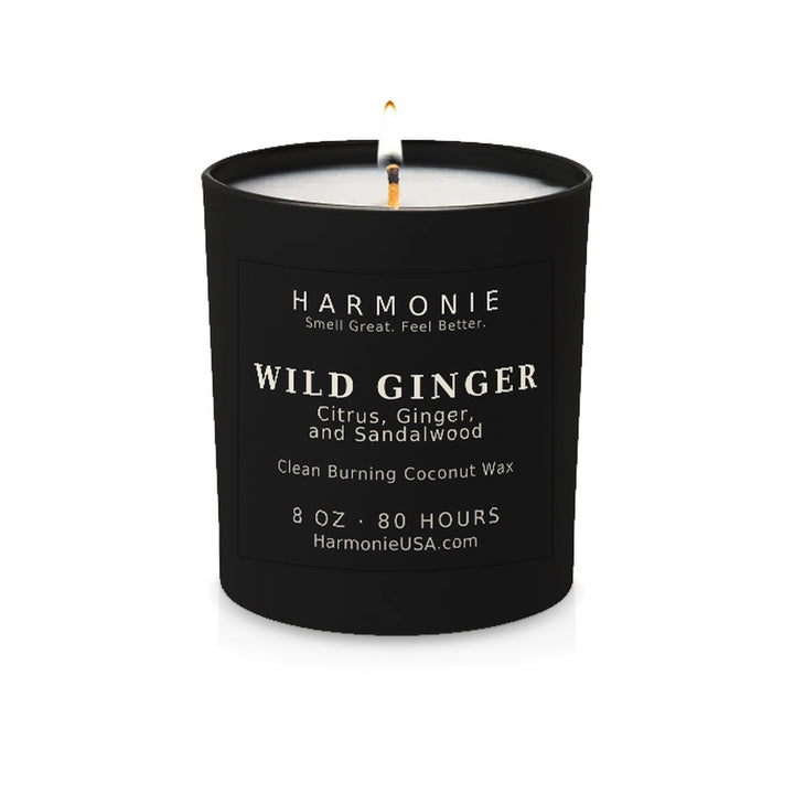 Harmonie Wild Ginger coconut wax candle, 8 oz, 80 hour burn time, matte black glass vessel with a single lit wick, on a white background