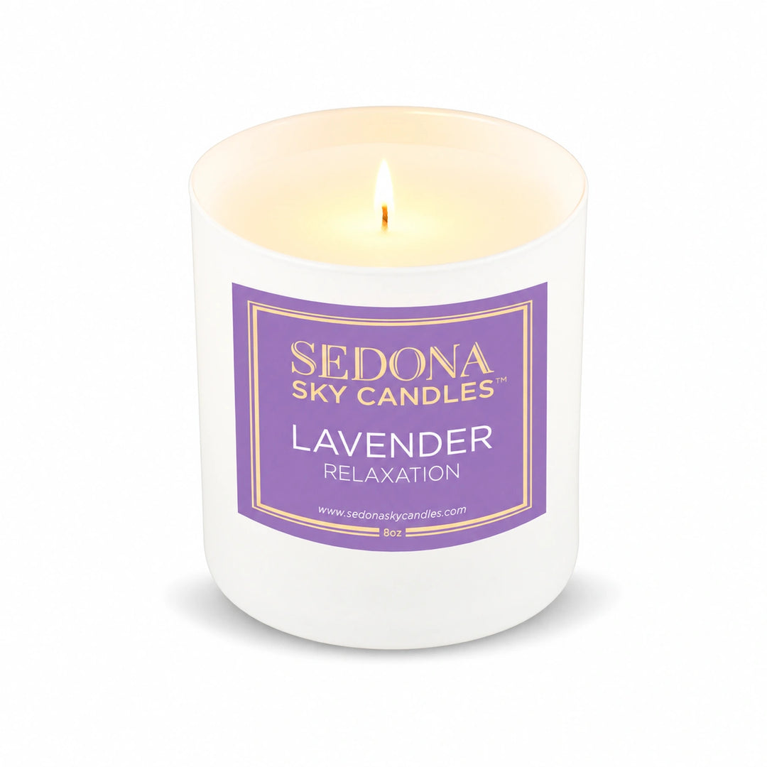 Lavender coconut wax candle, 8 oz, by Harmonie, lit with a glowing flame on a white background
