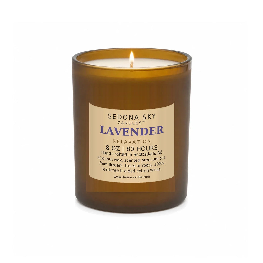 Sedona Sky Lavender Relaxation candle, 8 oz amber glass jar with matte Amber Sand label, lit wick and visible wax pool, on a seamless white background