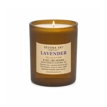 Sedona Sky Lavender Relaxation candle, 8 oz amber glass jar with matte Amber Sand label, lit wick and visible wax pool, on a seamless white background