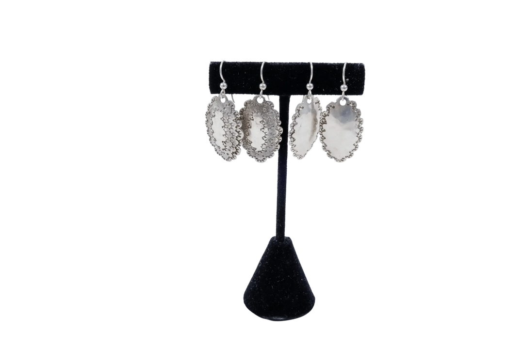 Roosevelt dime earrings on a black display stand showing the hammered face