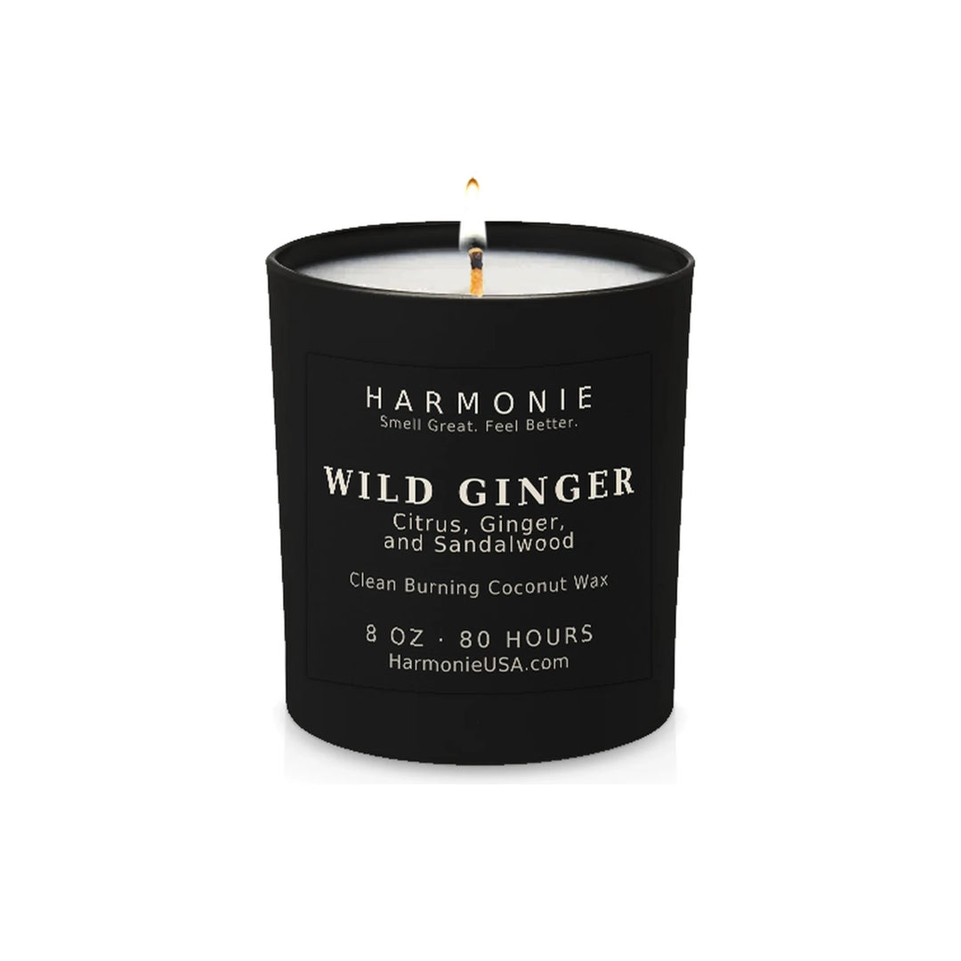 Harmonie Wild Ginger coconut wax candle, 8 oz, 80 hour burn time, matte black glass vessel with a single lit wick, on a white background